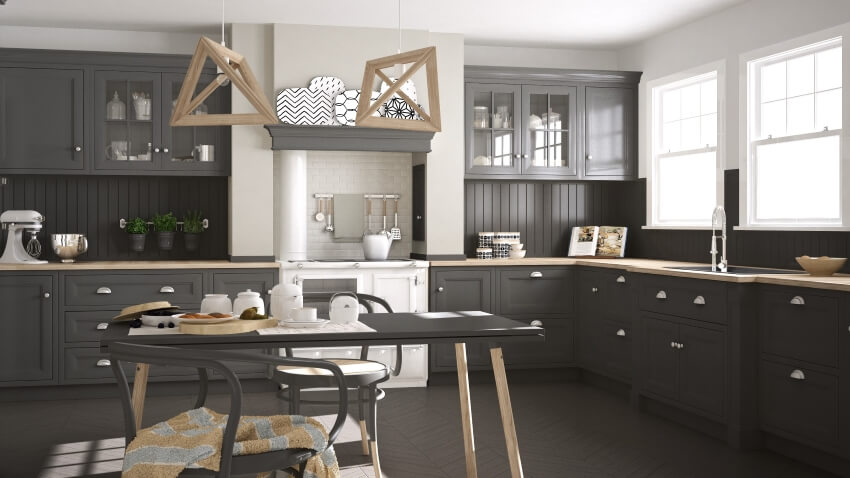 Classic gray kitchen with wood panel backsplash, short counter column, and stylish pendant lights