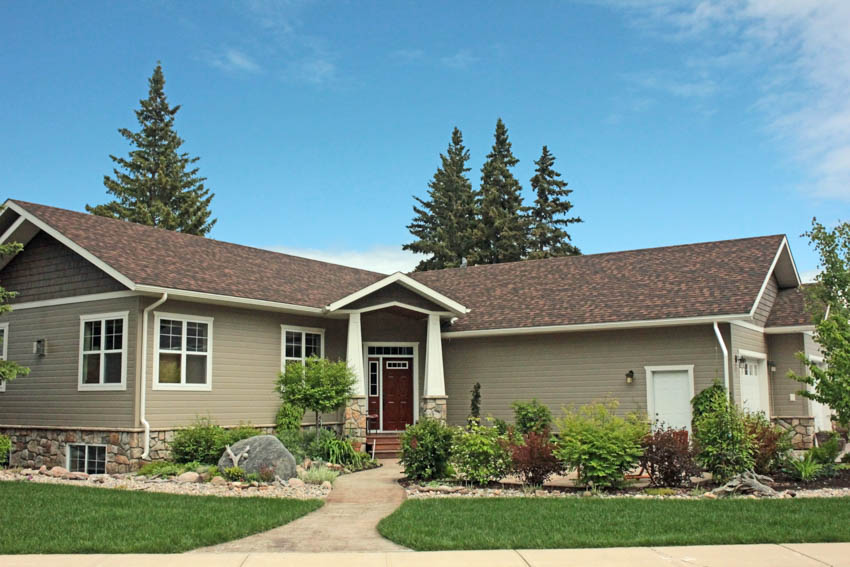Craftsman ranch with siding, pitched roof, front porch, door, windows, hedge plants, and walkway
