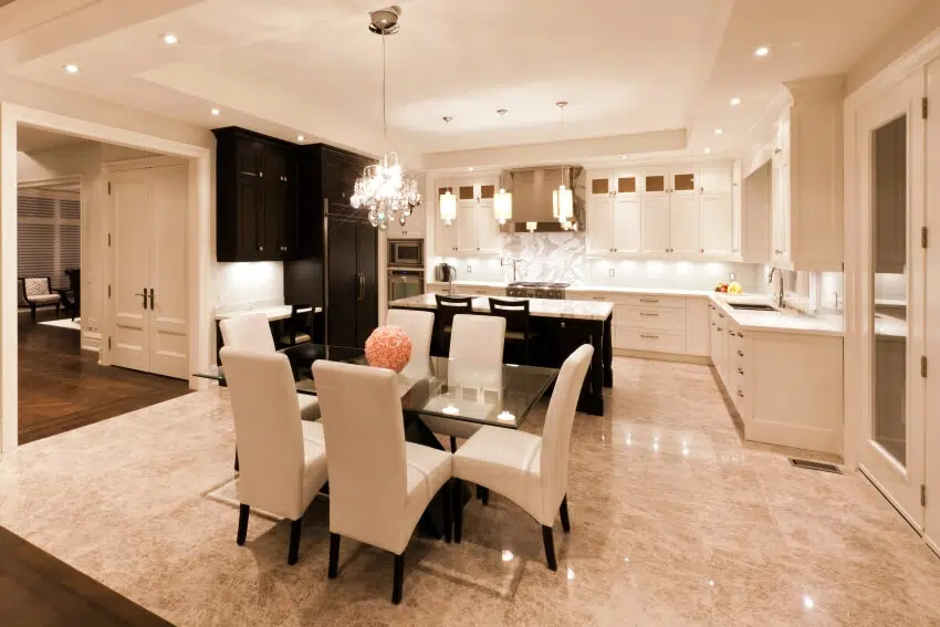 Kitchen with cream walls, chandelier, breakfast counter and dining set