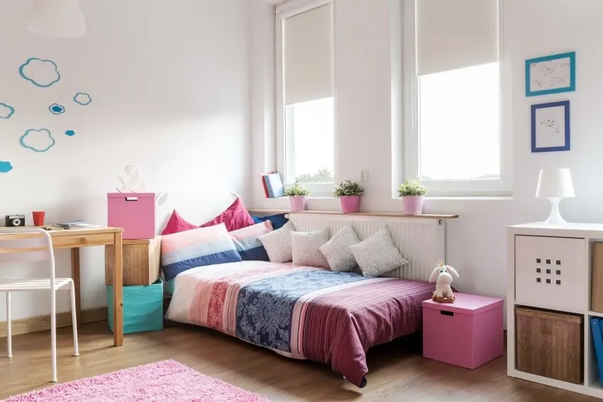 Room with pink, white and wooden accents, stackable boxes and glass windows