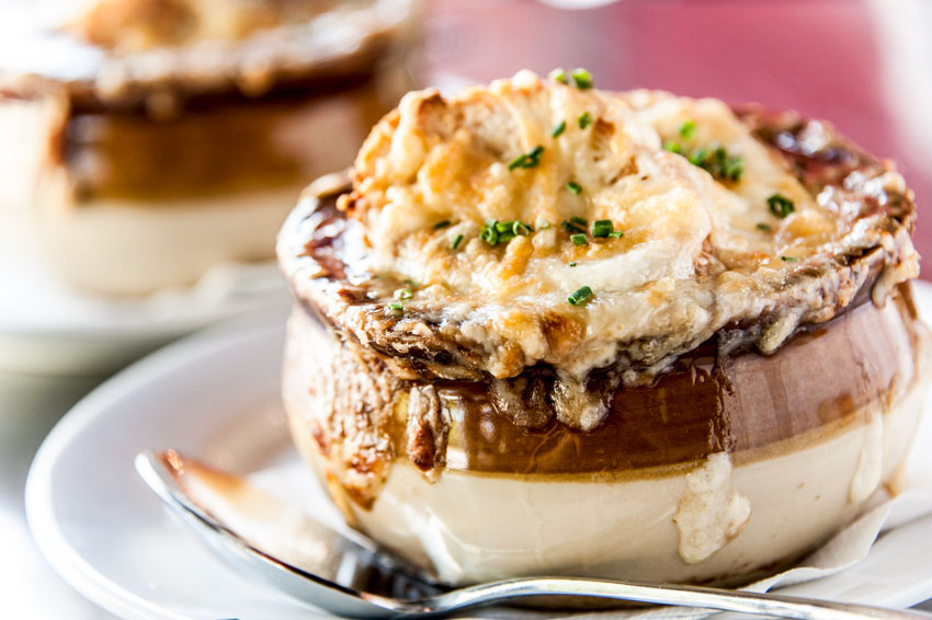 Dining bowl with French onion soup in it