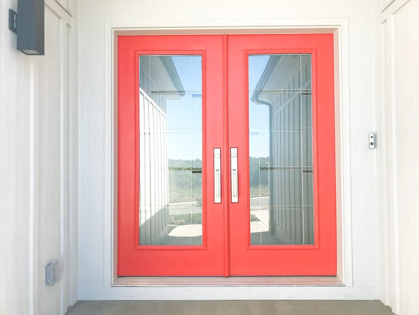 Double front doors with frosted glass and red frame