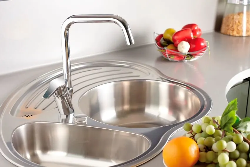Drop in kitchen sink with faucet and fruits on the side