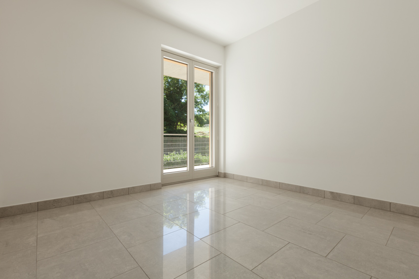 Empty room with glazed porcelain tile and glass door