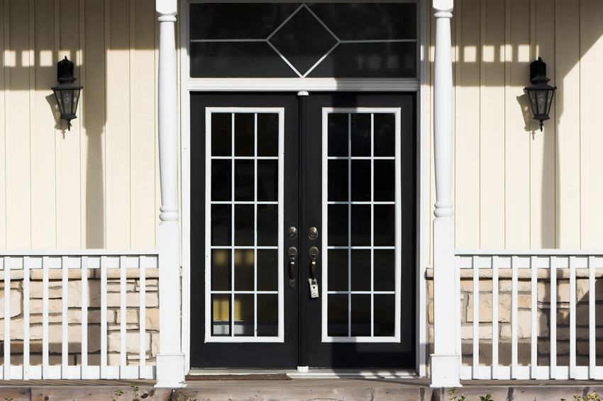 Front porch with black doors, white trim, railings, and siding