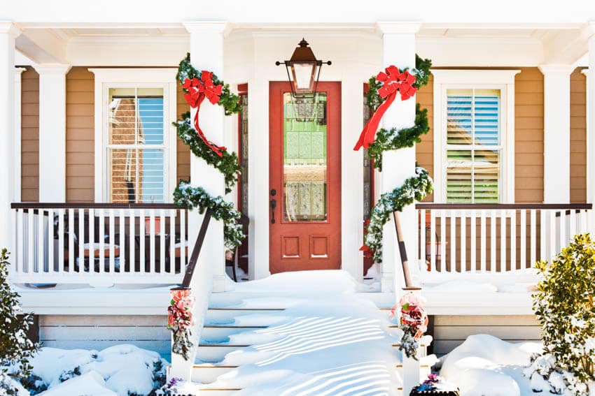 Front porch with frosted glass front door, railings, and windows