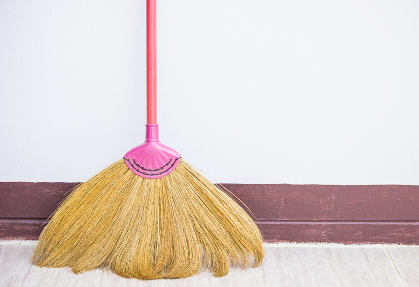 A handmade broomstick from grass on concrete wall