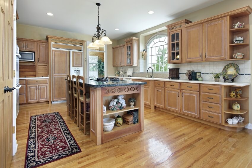 Hardwood floor large island and a chandelier in an arts and crafts kitchen design