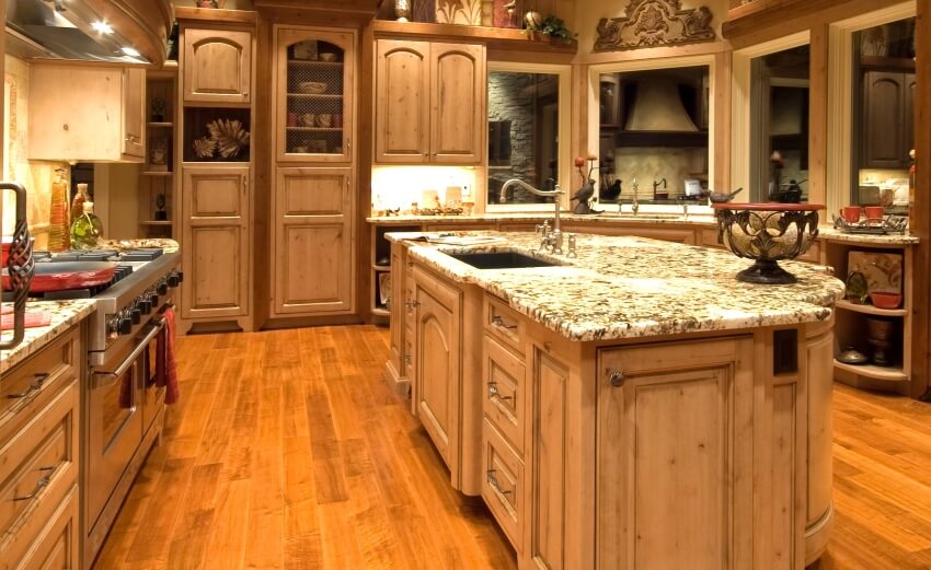 Hardwood floors, cedar cabinets, and granite countertops in a luxurious kitchen interior