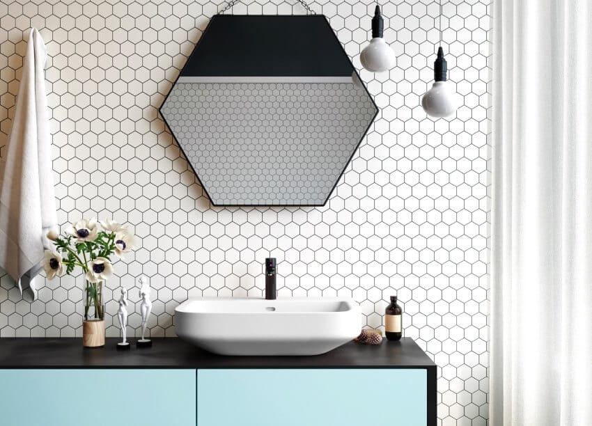 Interior of a modern bathroom with pendant lights, a hexagon penny tile backsplash and mirror