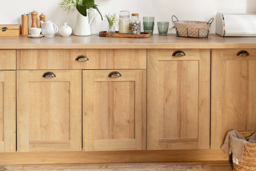 Kitchen with Shaker-style cabinet doors, countertop, and hardware