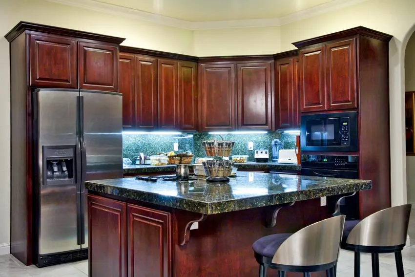 Kitchen with cherry cabinets, and green granite countertops