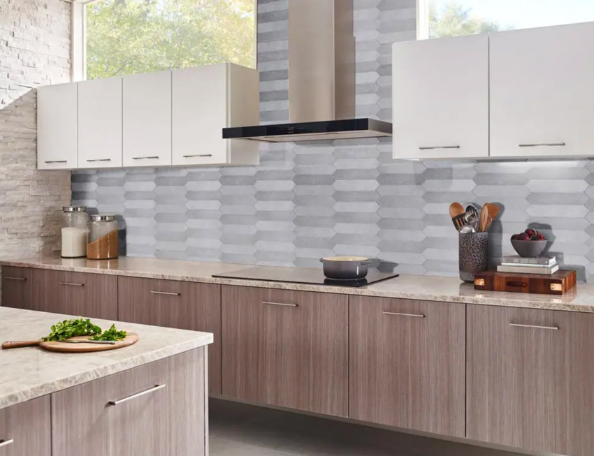 Kitchen with cabinets, countertop, windows, range hood, stove, and horizontal picket tile backsplash