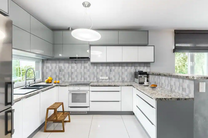 Kitchen with modular cabinets, tile flooring, ceiling light, and picket mosaic backsplash