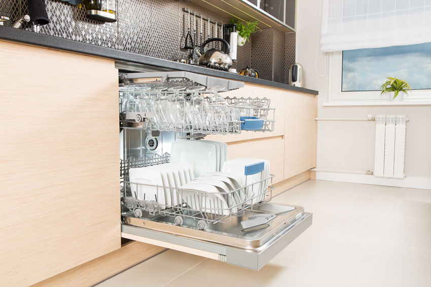 Open dishwasher with plates and bowls