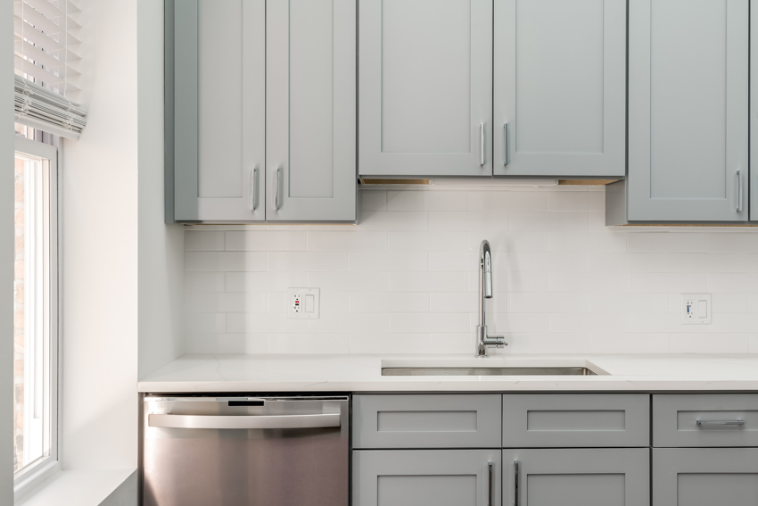 Kitchen with full overlay recessed cabinets, countertop, dishwasher, sink, and faucet