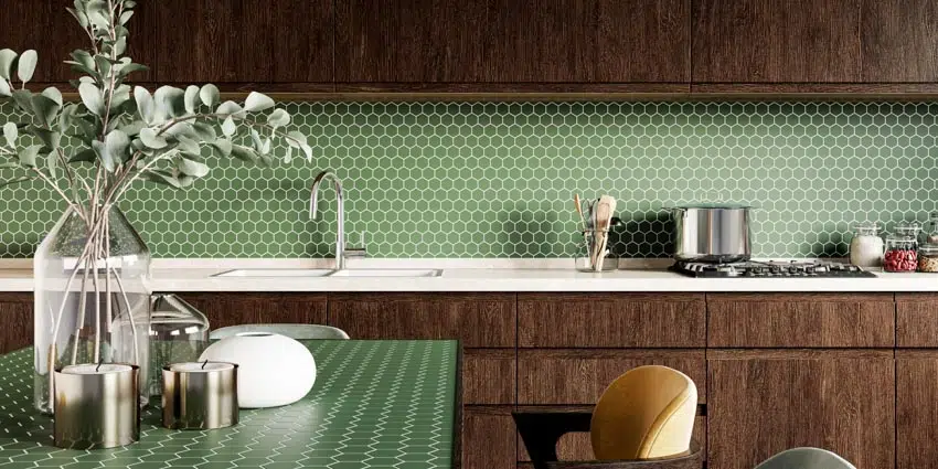 Kitchen with green backsplash, cherry cabinets, countertop, and kitchenware items