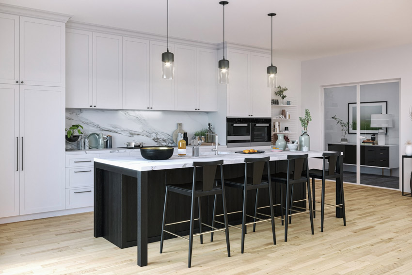 Kitchen with island, high chairs, pendant lights, porcelain backsplash and wood floors