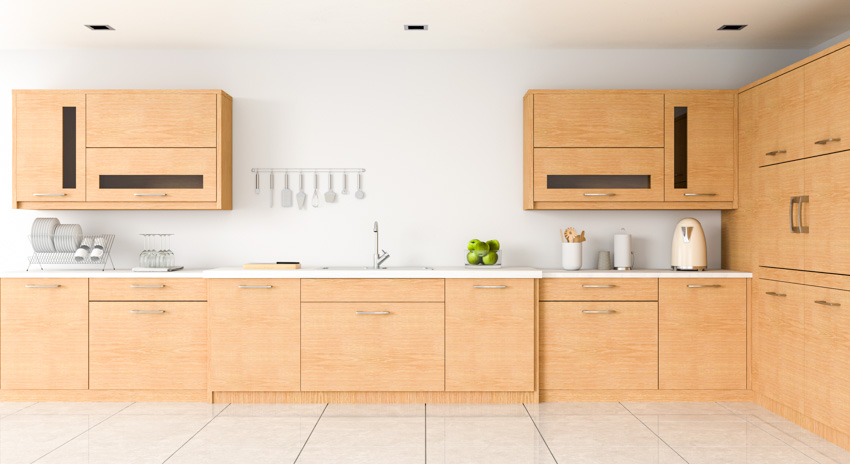 Kitchen with white walls, solid surface counters and porcelain floors