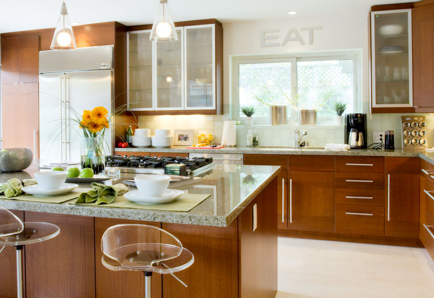 Kitchen with sandblasted frosted glass cabinets, island, countertops, bar stools, backsplash, window, and ceiling lights
