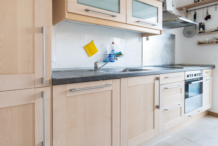 Kitchen with beech shaker cabinets, oven, backsplash, and countertop