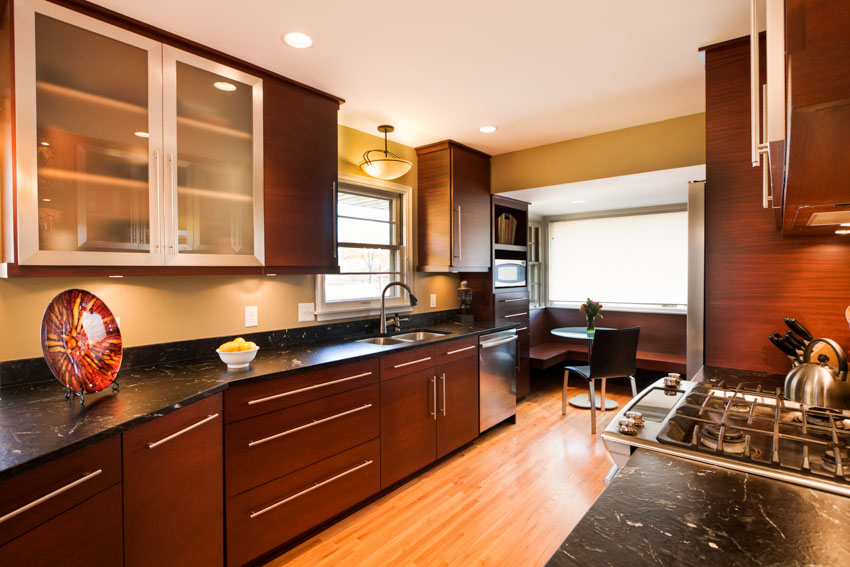 Kitchen with silkscreen frosted glass cabinets, countertops, drawers, window, stove, and wood flooring