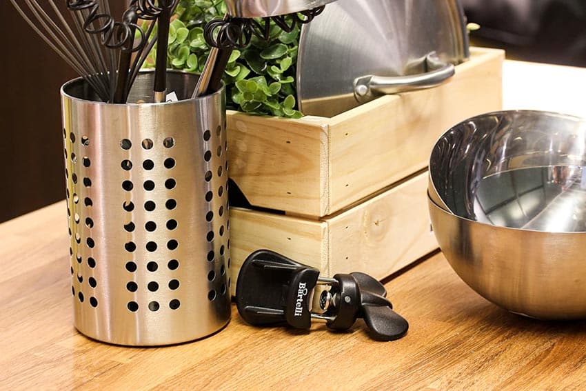 Kitchen with single wheel can opener on wood surface