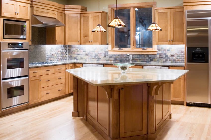 Kitchen with solid wood cabinets, countertop, porcelain brick tile backsplash, wooden floors, and pendant lights