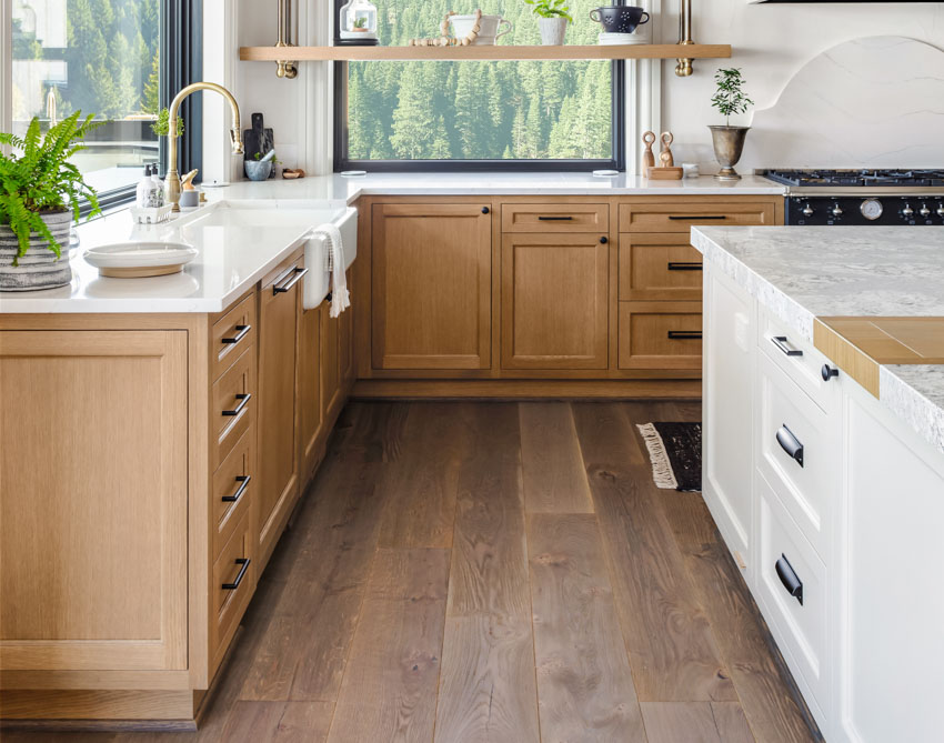 Kitchen with wood board floors, and medium-stain cabinets