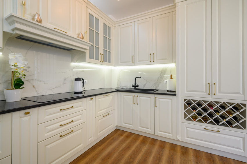 Kitchen with white cabinets, countertop, and backlit cabinets