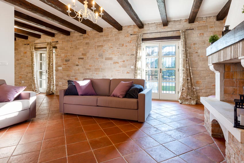 Faux Saltillo tiles on the floor, glass door and taupe couch