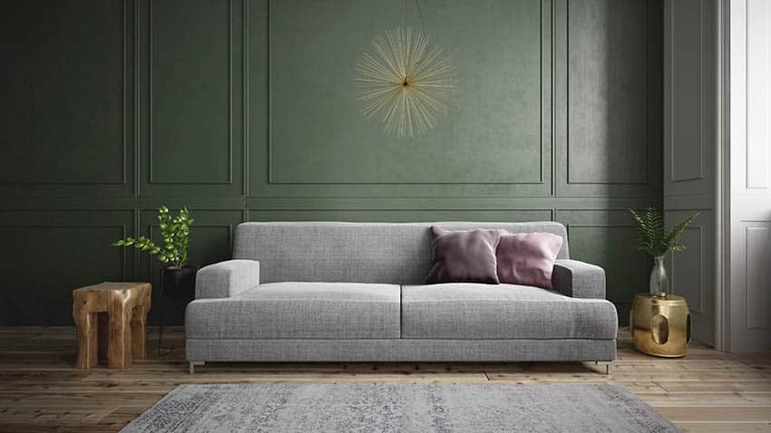 Living room with gray sofa and green panel walls