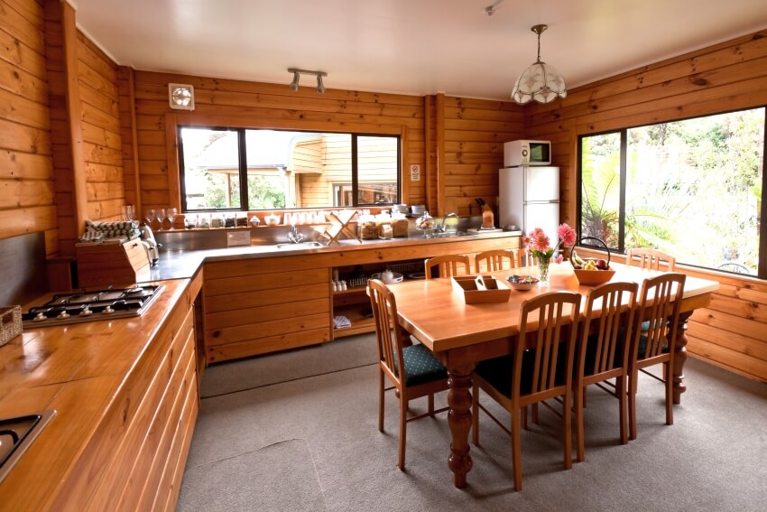 Lodge kitchen room with butcher block countertop and wood backsplash and walls
