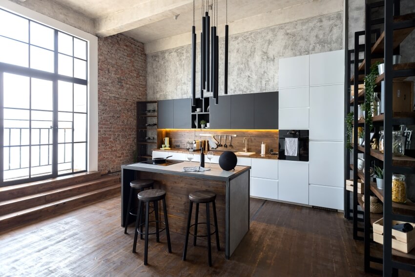 Loft style kitchen in dark colors with an island, wood backsplash, and concrete wall and ceiling