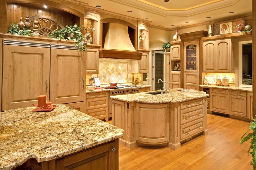 Luxurious kitchen with recessed lighting, white cedar cabinets, and granite countertops