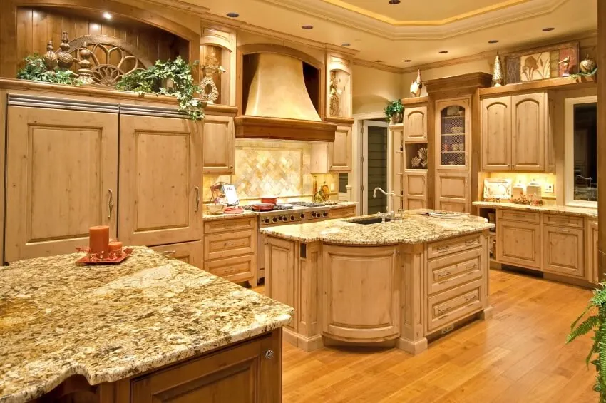 Kitchen with recessed lighting, cabinets and herringbone pattern backsplash