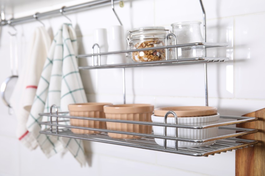 Metal bar with hanging attachments in kitchen