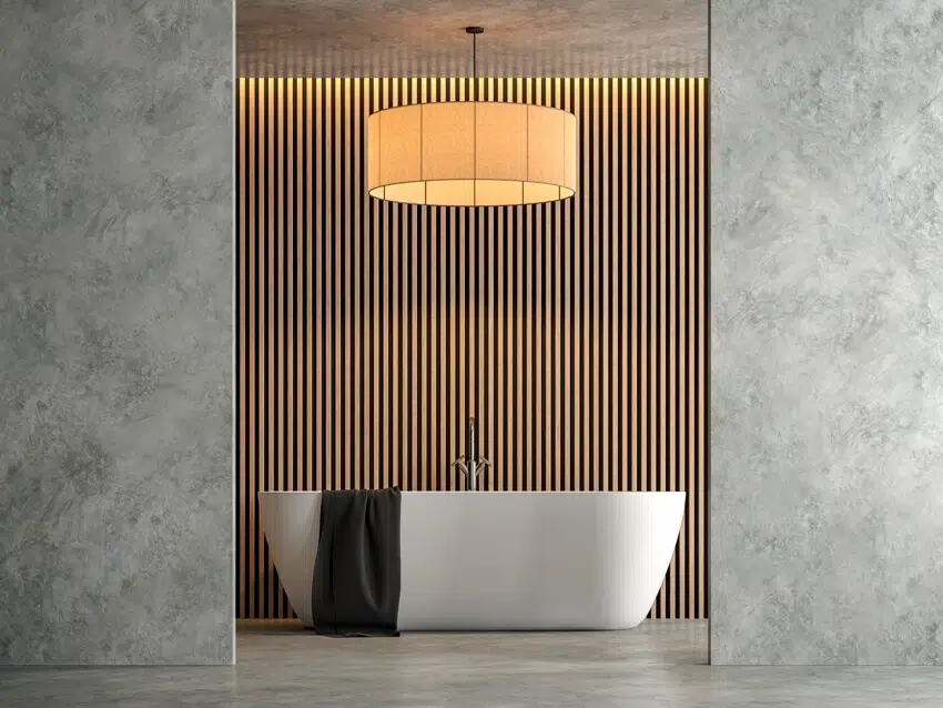 Bathroom with polished concrete walls, vertical fluted wall panels and bathtub 