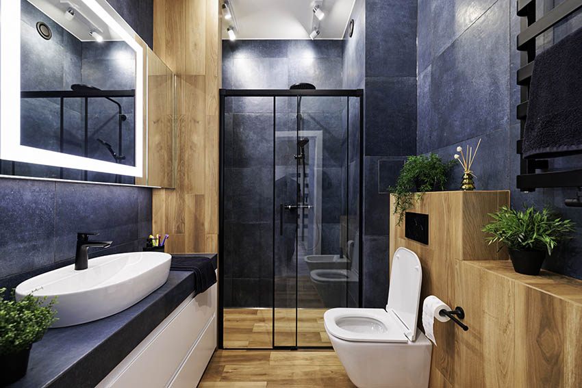 Modern bathroom with black granite tile walls dual flush toilet