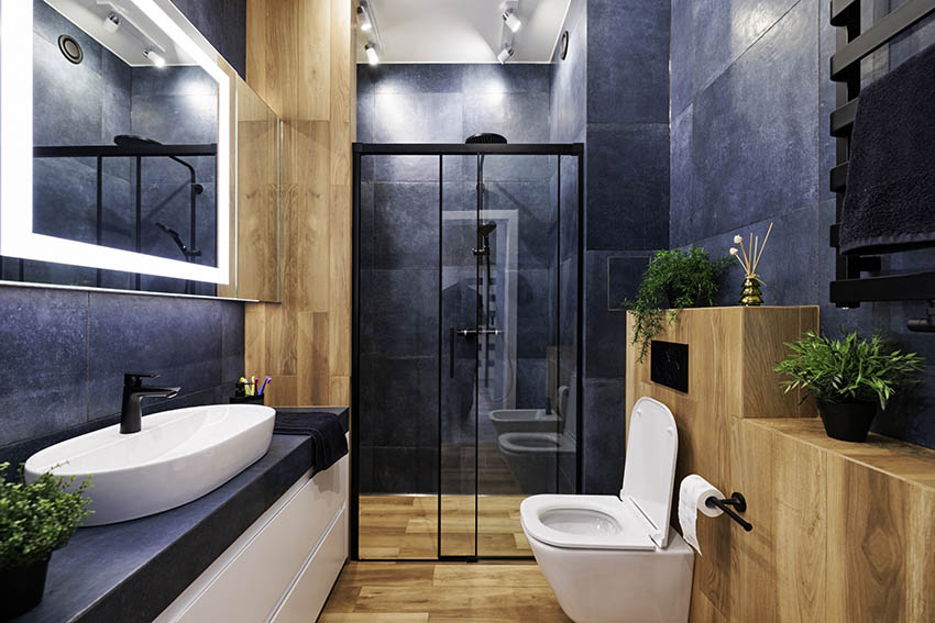 Modern bathroom with black granite tile walls dual flush toilet 