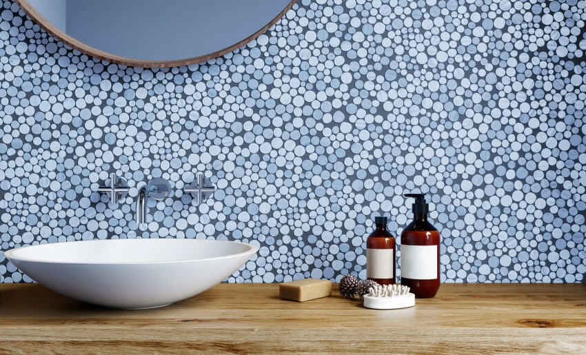 Modern bathroom with blue penny tile backsplash, and washbasin on a wooden shelf countertop