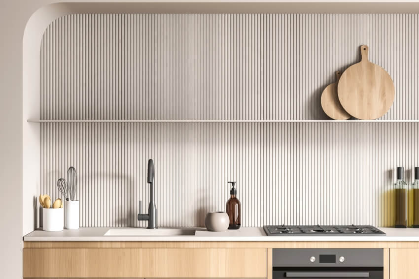 Modern white kitchen with long floating shelf, and wood slat backsplash