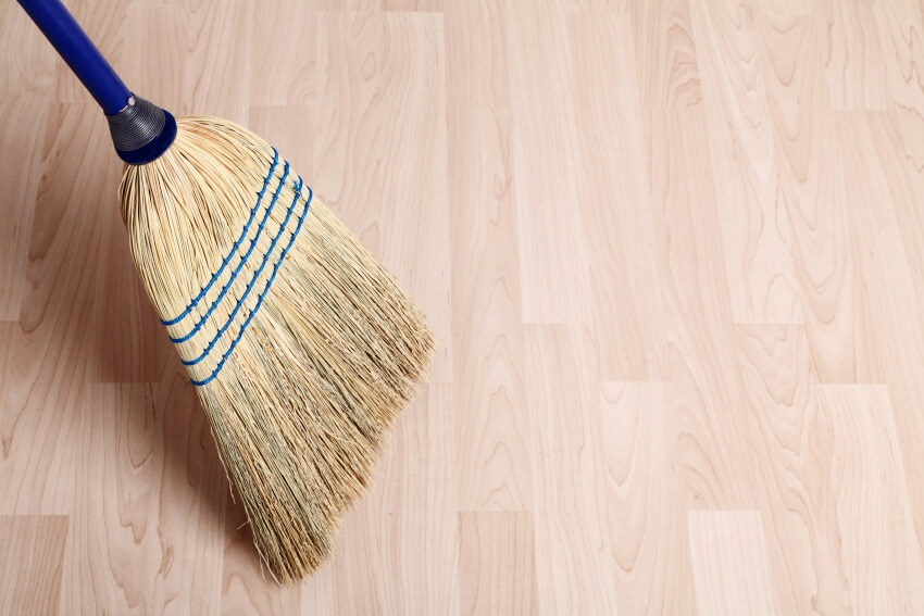 Old style broom with corn fibers on a new hardwood floor