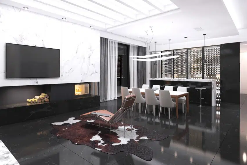 Open space with a fireplace, skylight, windows and ceiling mounted lights