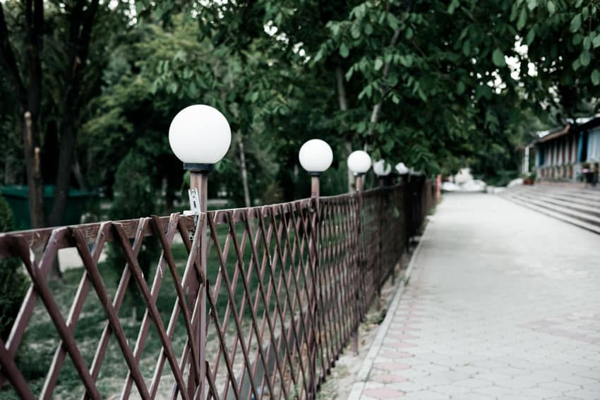 Outdoor fence made of wood with globe lights