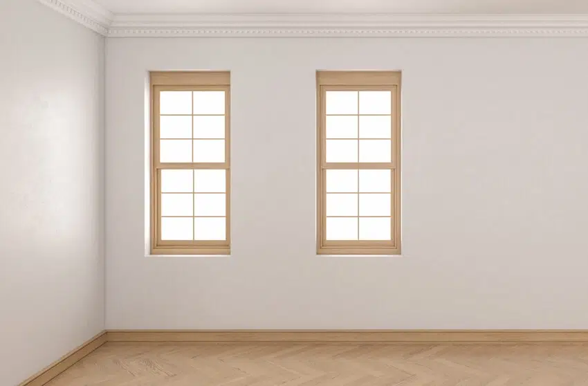 Room with plaster walls with single hung windows