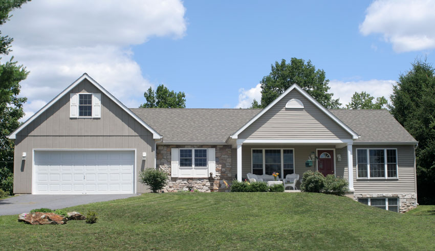 Ranch home with garage dormer and window shutters