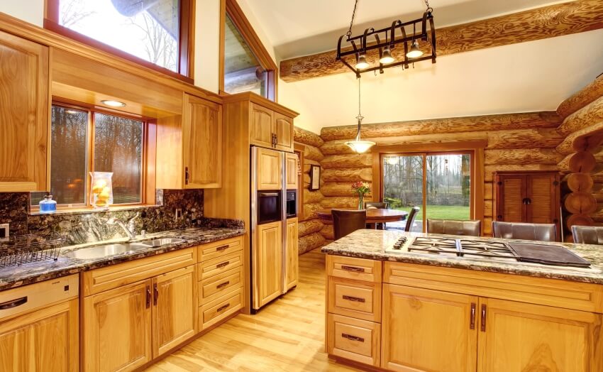 Log cabin kitchen with solid wood cabinets, and clerestory windows