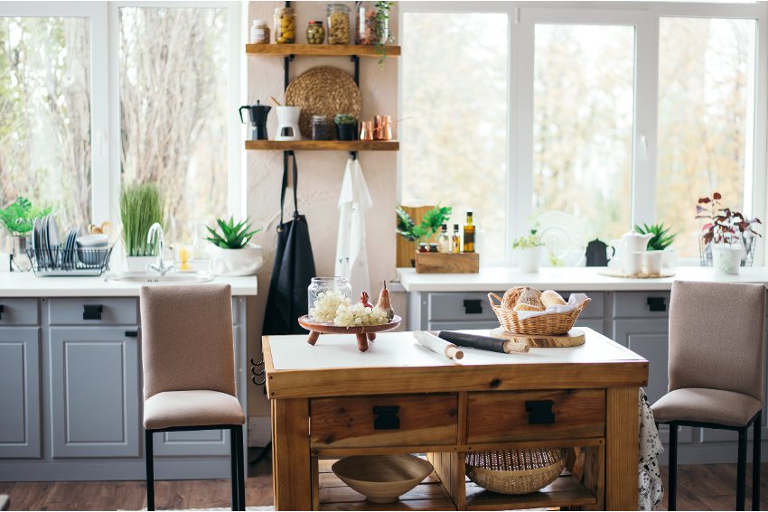 Rustic kitchen design with suspended shelving, small wooden island with chairs and gray cabinets