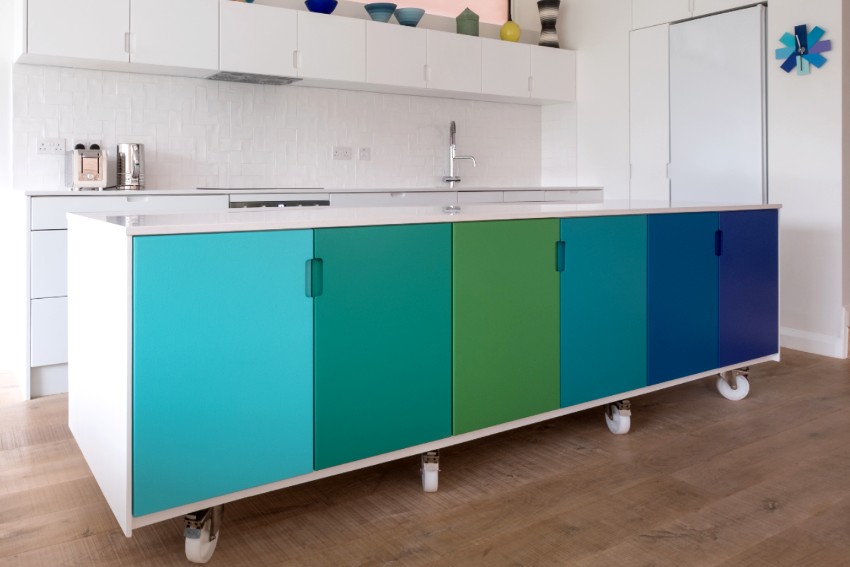 A simple kitchen with retro design portable kitchen cart painted in blue and green ombre colours